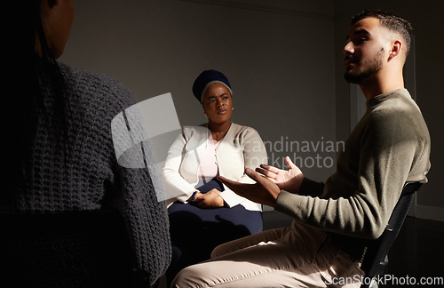 Image of Support, man talking to women and group therapy help with understanding, sharing feelings in counselling session. Mental health, addiction and depression, people in grief together with therapist.