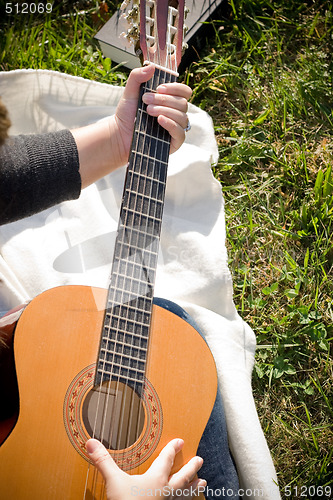 Image of Girl Playing a Guitar