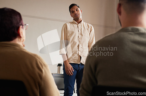 Image of Support, man standing and introduction to group therapy, help, advice in sharing feelings and talking in session. Mental health, grief or depression, men and women listening to therapist and together