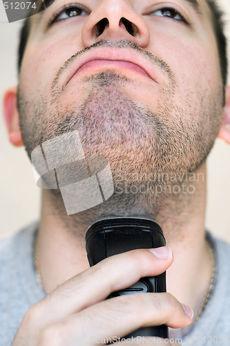 Image of Young Man Shaving