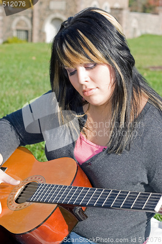 Image of Girl Playing a Guitar