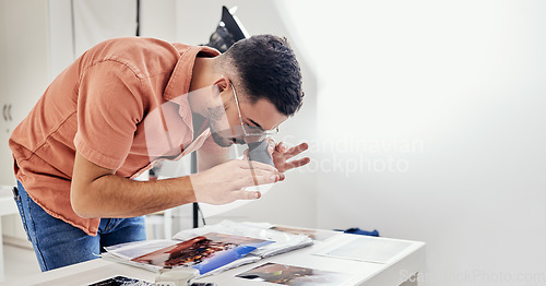 Image of Photography, editing and man photographer in a studio working on fashion or creative images. Art, creativity and male analyzing pictures from a photoshoot at a digital, design or production agency.