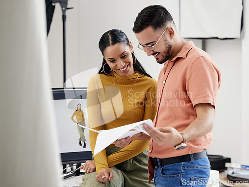 Image of Documents, collaboration or photoshoot with a photographer and model in a studio for creative production. Teamwork, designer or fashion with a designer man and woman at work on a magazine shoot