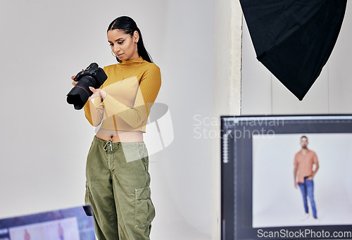 Image of Serious, photographer and woman with camera in studio for shoot, magazine project or online content. Backstage, focus or girl videographer thinking for digital web fashion design or creative career