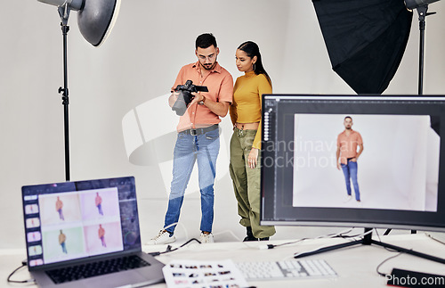 Image of Collaboration, photographer and startup people in studio set with camera for shoot, magazine project or online content. Planning or teamwork examine picture for digital catalog or fashion web design