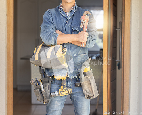 Image of Handyman, tool bag and arms crossed at work with goals, property development and real estate maintenance. Construction worker, tools and renovation industry with service, vision and home improvement
