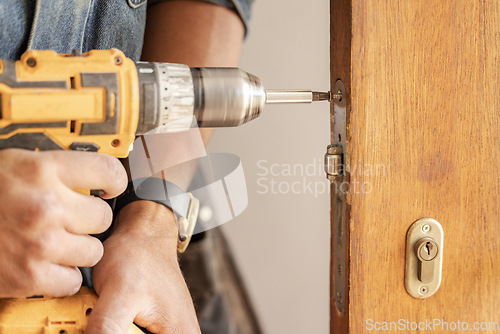 Image of Handyman, drill door and wood for handle at workplace, industry and home development goals. Hands, tools and construction worker with maintenance, property management and diy carpenter for building