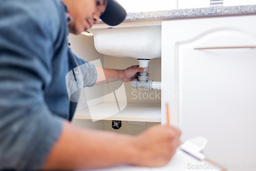 Image of Plumber, checklist and pipe in home kitchen, workplace or industry for property development vision. Black man, construction worker and writing with notes, idea and paper for diy, interior and design
