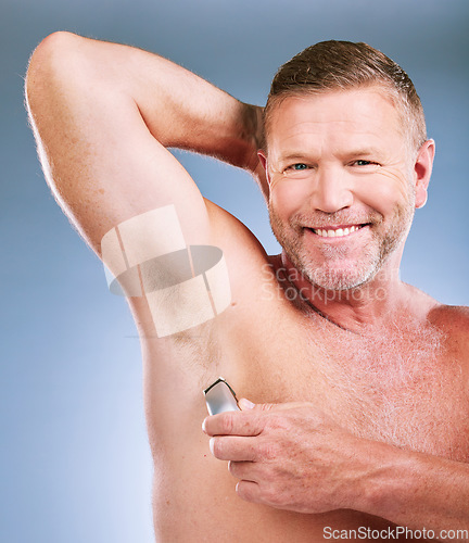Image of Electric razor, senior man armpit and portrait of an elderly model smile for grooming wellness and shave. Hygiene, cleaning and body hair maintenance of a person in isolated blue background studio