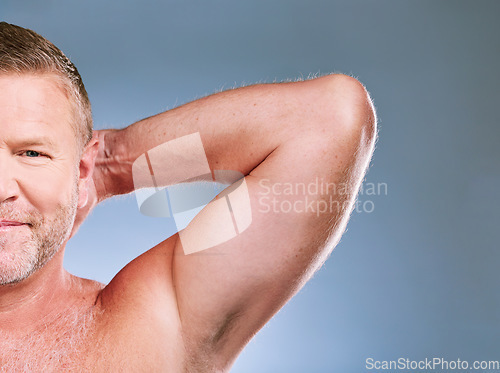 Image of Portrait, skincare and armpit with a mature man in studio on a gray background for hygiene or grooming. Face, beauty and underarm with a male posing to promote body care, wellness or fitness