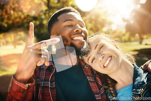 Image of Couple smile, selfie peace sign and portrait outdoors, enjoying fun time and bonding at park. Interracial, love romance and black man and woman with v hand emoji for taking pictures for happy memory.