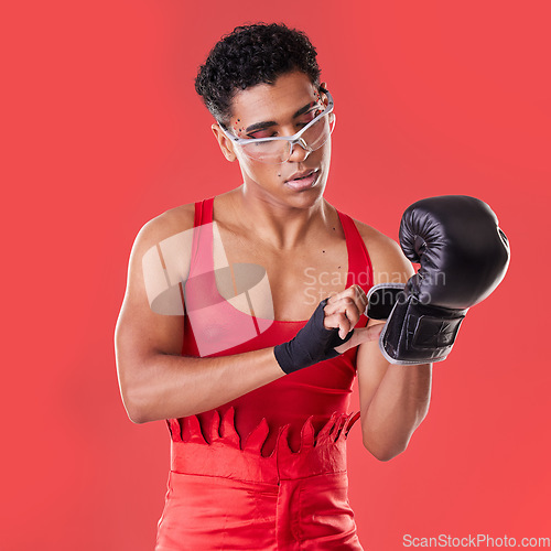 Image of Gay man, studio and boxing glove on hand with punk costume, makeup and lgbt aesthetic by red background. Young bodybuilder, gen z fighter and fitness with strong body, self care and pride for boxer