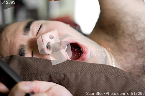 Image of Man Yawning In Bed