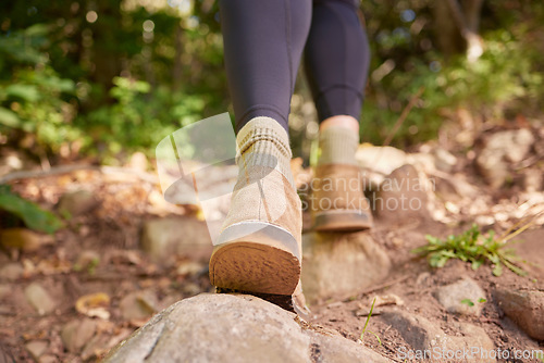 Image of Ground, woman shoes and hiking in forest, nature and rock path for wellness, exercise and outdoor adventure. Hiker girl, boots and freedom in woods, forrest and walk to explore landscape on holiday
