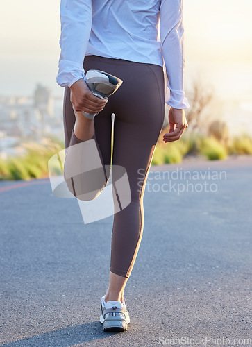 Image of Fitness, leg and stretching by woman in road for running, training and exercise at sunset, body and warm up. Runner, stretch and rear view of girl at sunrise for cardio, marathon or practice run