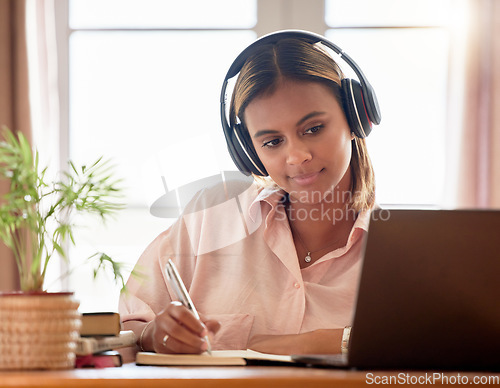 Image of Woman, student with laptop and headphones, writing notes in notebook, education and elearning with study notes. Mexican female, internet with wifi and tech, online class with webinar and studying