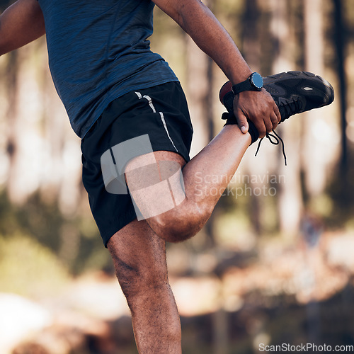 Image of Black man, stretching legs and exercise outdoor in nature forest for fitness and healthy lifestyle. Sports person doing workout, training and muscle warm up for cardio body health and wellness