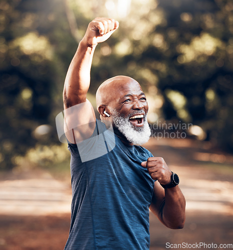 Image of Park, success and running, winning black man excited and celebration at fitness run in nature with earphones. Music, workout and mature runner with smile and happy to celebrate exercise achievement.