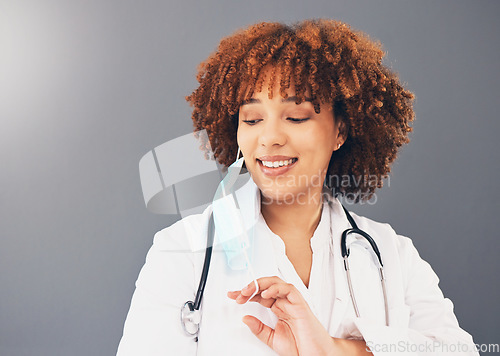 Image of Black woman, doctor and Covid, remove face mask and health, end of pandemic and protection on studio background. Face, smile and mockup with healthcare, safety from virus and positivity with female