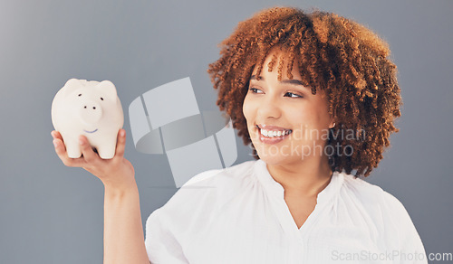 Image of Happy, piggy bank or black woman with savings budget or financial profits growth on studio background. Smile, finance or African American girl holding financial tin for cash loan or money investment