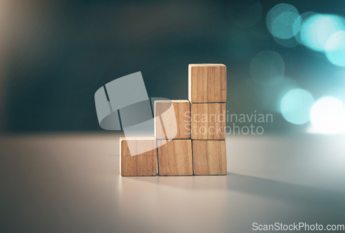 Image of Building, investment and blocks for business, planning and strategy with stable foundation on a table. Growth, creative and conceptual design for economy, value and finance interest on a desk