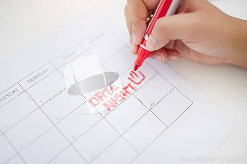 Image of Hands, writing and calendar planning date for schedule, commitment or organized reminder on paper. Hand of person with red marker to write plan, time or day for operation, goals or monthly planner