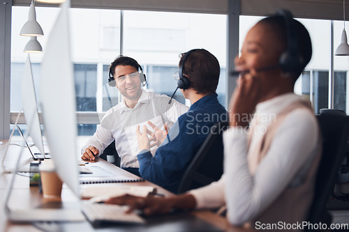 Image of Call center, telemarketing and employees talking, customer service and explain system in office. Team, coworkers and consultants in workplace, tech support and conversation for process and training