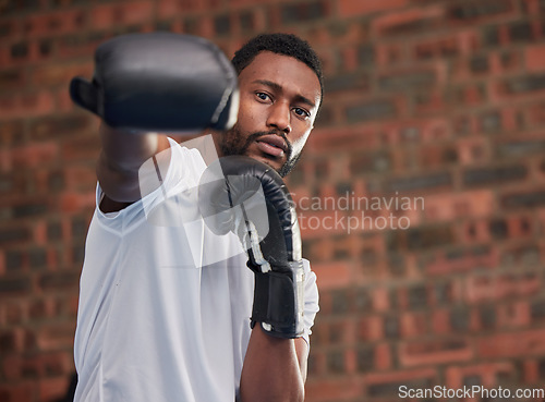 Image of Fitness, boxing and portrait of a black man in gym doing a intense cardio workout with gloves. Sports, exercise and African male boxer athlete training or practicing for match, fight or competition.