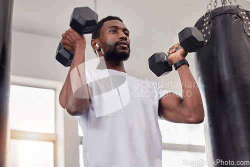 Image of Earphones, exercise music and black man with dumbbells in gym for workout, training or fitness. Sports, bodybuilder and male athlete streaming radio podcast while lifting weights for muscle strength.