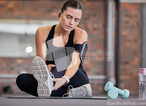 Image of Leg pain, fitness and woman with injury in gym after accident, workout or training. Sports, health and young female athlete with fibromyalgia, inflammation or arthritis, tendinitis or painful ankle.