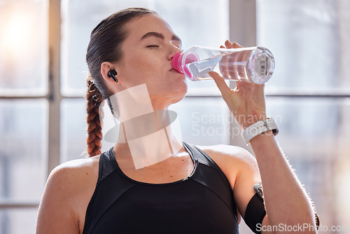 Image of Fitness, drinking water and woman in gym for health, wellness or hydration. Sports, nutrition or thirsty female athlete with liquid after training, workout or exercise, running or cardio for strength