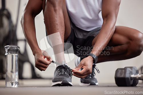 Image of Hands, fitness and tie shoes in gym to start workout, training or exercise practice. Sports, health and black man or athlete tying sneakers to get ready for exercising, running or cardio for wellness