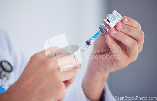 Image of Doctor, hands and covid vaccine with syringe for cure, illness or flu shot at the hospital. Hand of medical professional extracting vial for corona virus immunization, vaccination or disease