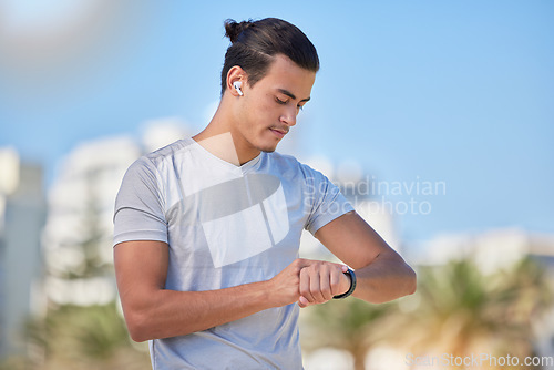 Image of Smartwatch, fitness and man checking running, health and cardio progress while training in a city. Digital, heart and pulse tracker for guy runner outdoor for performance, monitor and exercise app