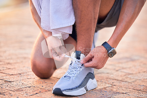 Image of Closeup, outdoor and man with fitness, shoelace and runner with wellness, training and healthy lifestyle. Zoom, male athlete and guy with smartwatch, tying shoes and exercise for workout or endurance