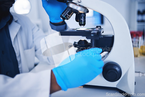 Image of Science, microscope and hands of a scientist in a lab doing research, experiment or test. Innovation, biotechnology and female scientific researcher working with equipment to examine in a laboratory.