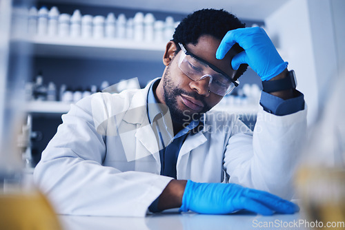 Image of Burnout, stress and scientist black man with a headache during medical research in a lab or laboratory frustrated and sad. Exhausted, fail and tired professional technician suffering from fatigue