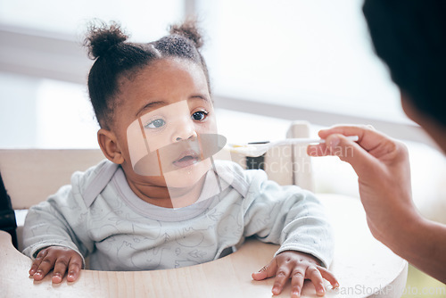 Image of Food, breakfast and parent feeding a baby in the morning while eating porridge with a mother. Hungry, feed and African child ready to eat a meal, lunch or dinner with a mom in a family home