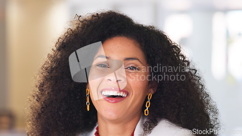 Image of Professional woman working on tablet device. Young female is in an office, sitting on a desk, smiling and busy with her job. As an accountant or lawyer, she is speaking to a client or coworker.