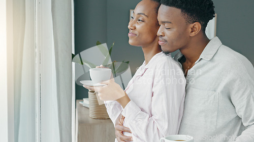 Image of Black couple, hug and morning coffee while showing love and care and looking out the window to watch the view on honeymoon vacation. Happy black man and woman in a committed and healthy relationship