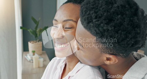 Image of Morning, window and couple hug in bedroom for cute embrace with warm beverage and cheek kiss. Bond, intimacy and care in relationship with black people who love living together in apartment.