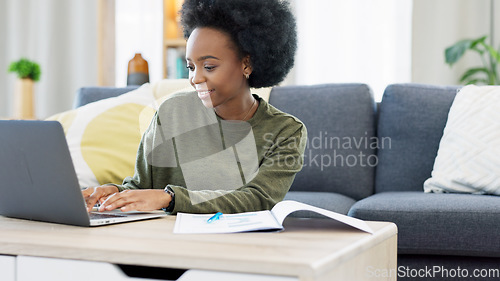 Image of Female student studying using laptop and making notes to prepare for exams or research for college assignment. African woman highlighting information while learning and doing online course from home