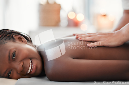 Image of Black woman, smile and back massage at spa in relax for physical therapy, zen or stress relief at resort. Happy African American female smiling relaxing for healthy wellness, body care or treatment