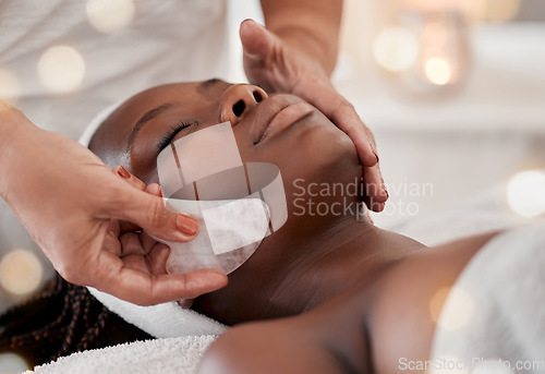 Image of Black woman, gua sha massage and luxury face treatment of a young female with spa facial. Skincare, rose quartz tool and beauty in wellness clinic with client feeling calm and zen from dermatology