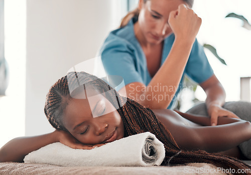 Image of Black woman, bed and smile for back massage, spa treatment or relaxation in stress relief at resort. Happy African American female relaxing with masseuse massaging with elbow for physical therapy