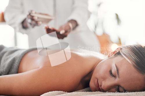 Image of Woman, spa and luxury back massage on table for health, zen and wellness of body. Client with a masseuse for healing, relax and therapy with self care and cosmetic service for detox and holistic time