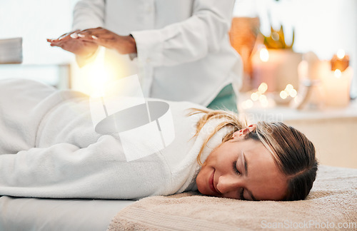 Image of Relax, reiki and woman on bed at spa for chakra therapy with light energy and holistic medicine. Spiritual healing, balance and zen, person with peaceful and healthy mindset at traditional massage.