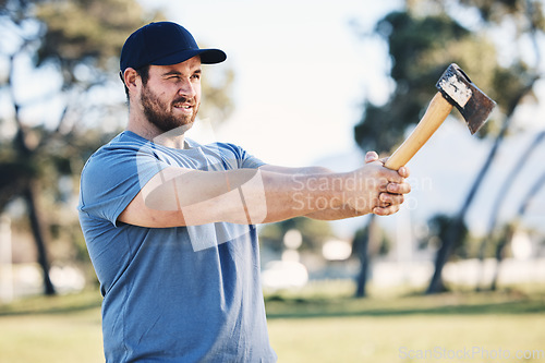 Image of Sports, archery and man throw axe on range for training, exercise and target practice competition. Extreme sport, fitness and male archer aim with tomahawk weapon for action, games and adventure