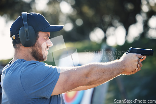 Image of Man, gun training and target for outdoor challenge, goals and aim for police, army or security academy. Shooting expert, pistol or firearm for sport, safety and combat exercise in nature with vision