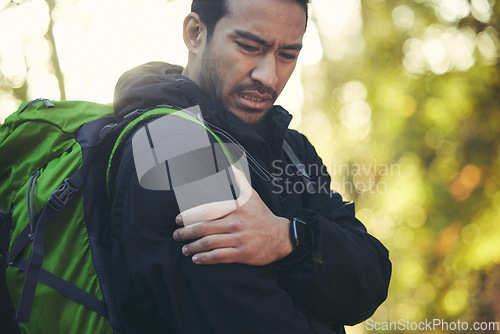 Image of Man, shoulder pain and hiking in forest, nature or woods with muscle crisis, anatomy problem or fitness accident. Medical, arm and injury emergency for athlete, backpacking hiker or healthcare stress